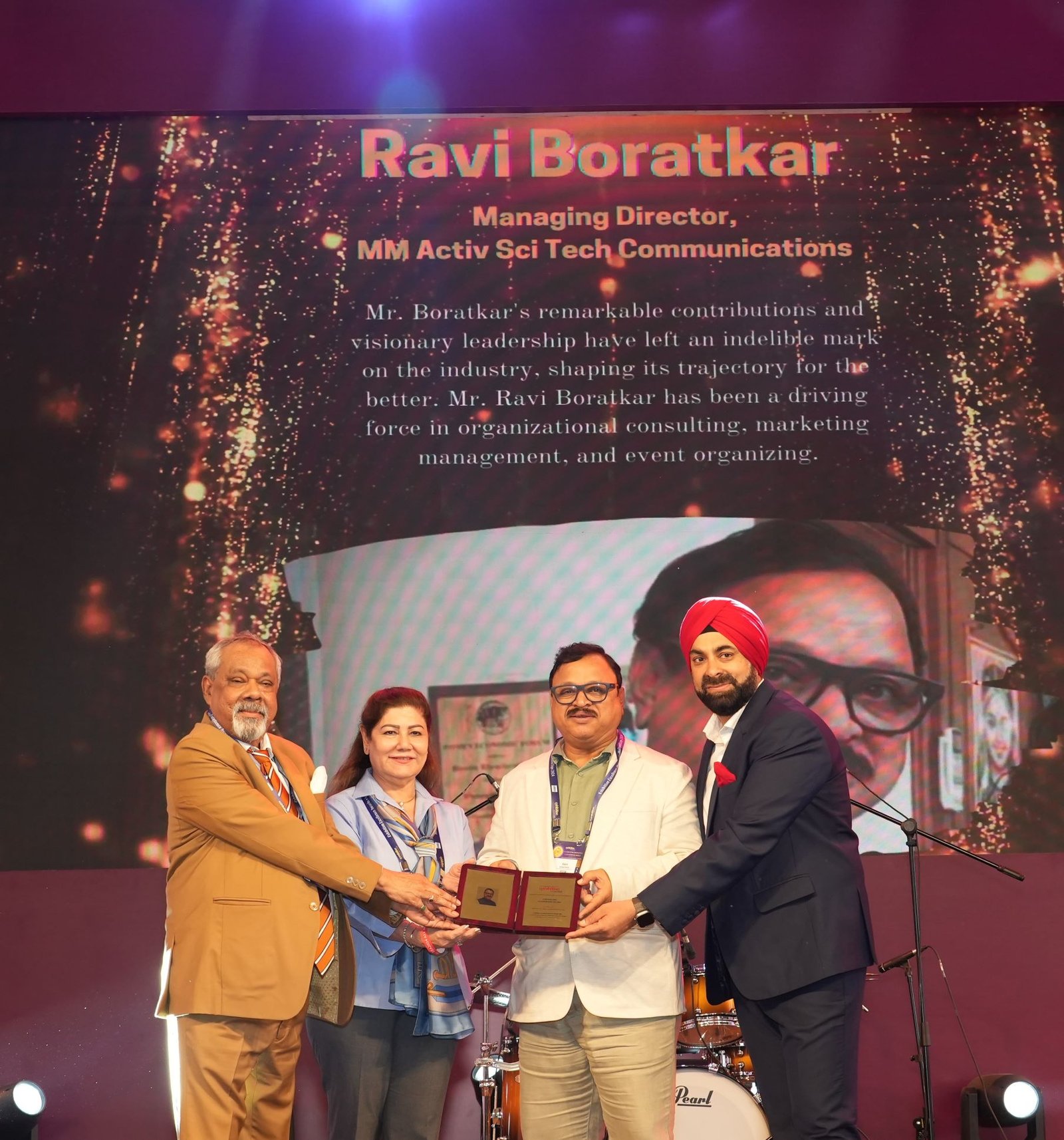Image caption: Ravindra Boratkar receiving Exemplary Leadership Award from dignitaries at the Exhibition Excellence Award ceremony